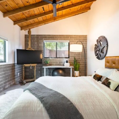 Bedroom 2 with queen bed, dedicated workspace + TV
