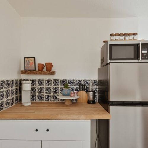 A bright and inviting kitchen space blending modern convenience with charming traditional tile accents, perfect for creating your own culinary adventures.
