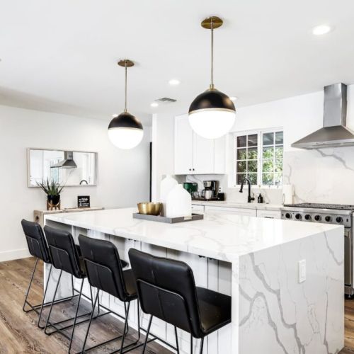 Waterfall kitchen island for a sleek modern design, fully stocked.