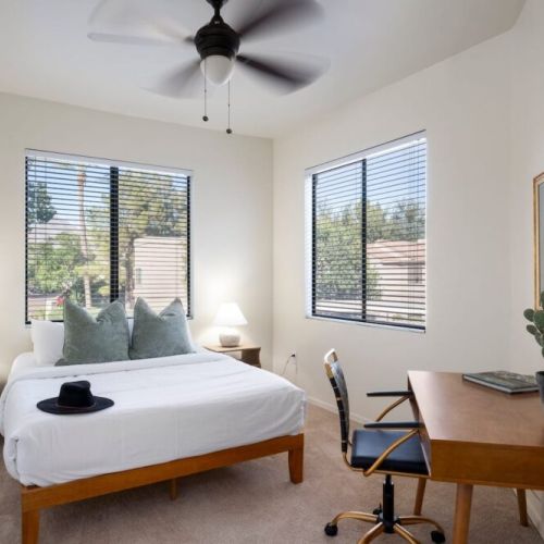 Secondary bedroom with Queen Bed, desk and chair.