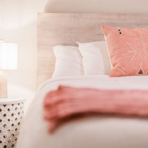 Queen bed with luxury mattress and hypoallergenic pillows and adjacent charging stations