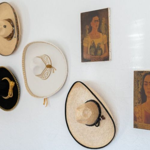 Vintage handpicked sombreros and a collection of Frida art.