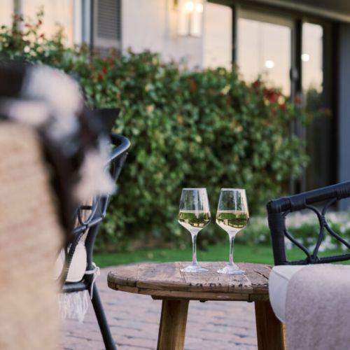 Our backyard has several curated spots for relaxing, lounging, sun bathing, putting and dining