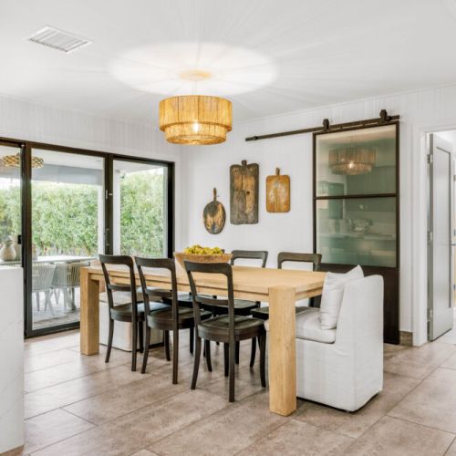 Thoughtfully displayed vintage cutting boards that ground the kitchen in moody, understated luxury.