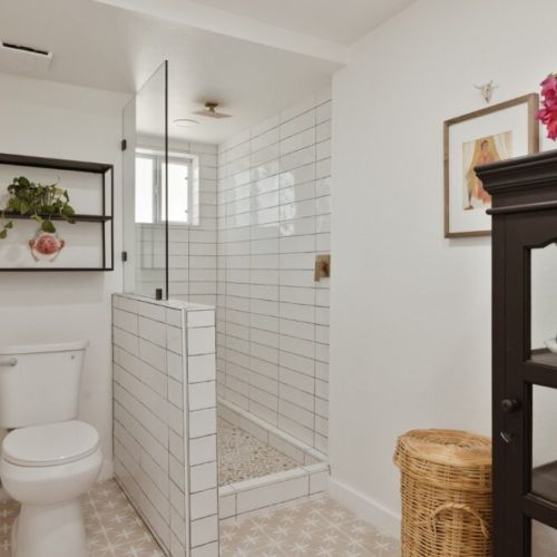 Bright, airy bathroom with a walk-in shower and earthy decor touches for a spa-like feel.