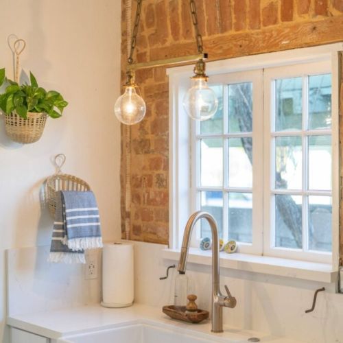 Original light fixture over farmhouse large sink