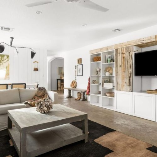 Custom built in wall unit with record player, TV, books and games