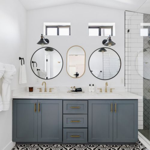 Clean and bright bath, with double sinks and a walk-in shower