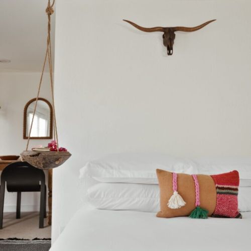Bright, cozy, and full of charm — The Frida’s bedroom blends Southwestern accents with soft, inviting touches for the perfect stay in this Spanish bungalow.