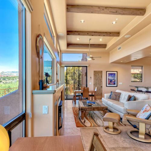 Living room space leading into the dining area and kitchen