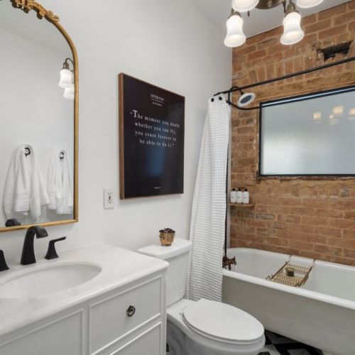 Claw foot tub with exposed brick