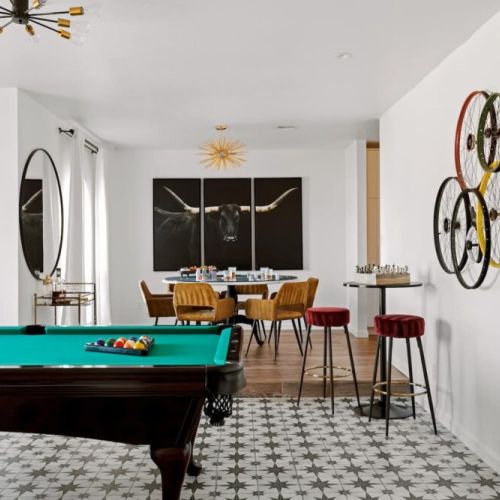 Fun open game room with 2 pub tables and lounge area