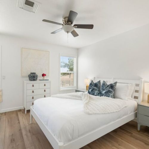 Guest bedroom 2 with queen bed, overlooking the pool with a private balcony