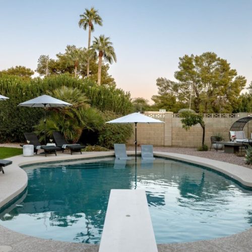 Take a dive or lounge in one of several comfy spots in this gorgeous backyard