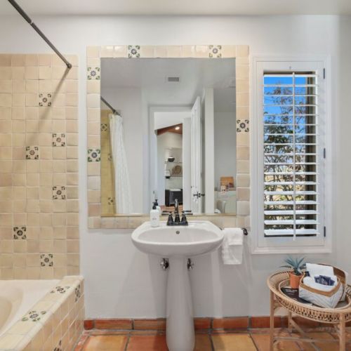 The bathroom is a true reflection of authentic Spanish charm, adorned with intricate hand-painted tiles that breathe life into the space.