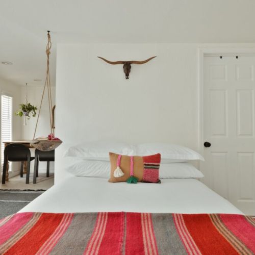 Southwestern charm: A serene bedroom with rustic decor and bold, vibrant textiles