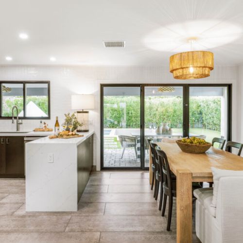 An elevated dining moment with a direct view of the sparkling pool.