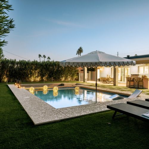 Stunning outdoor area with pool and state-of-the-art in-ground firepit and seating area.