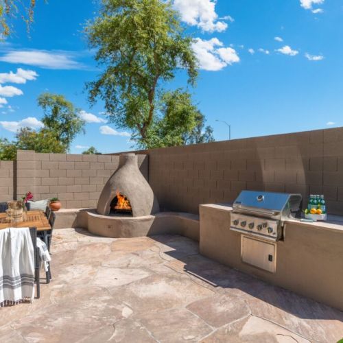 BBQ, fireplace and outdoor dining table