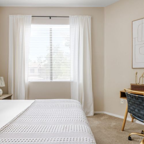 A stylish bedroom with a peaceful workspace for remote travelers.