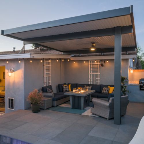 Nighttime ambiance perfection - string lights create enchanting atmosphere for poolside gatherings.