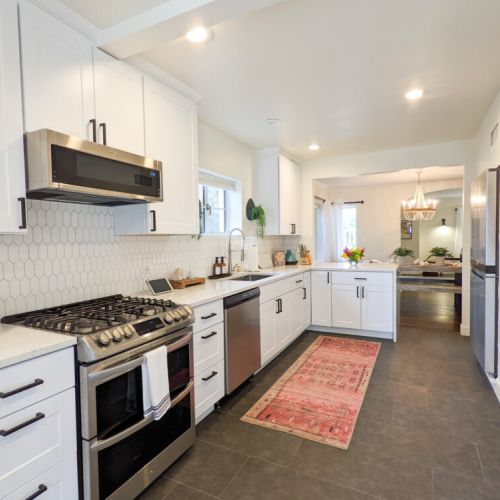 Convenient kitchen, stocked with utensils, dishes, pots and pans that you will use to prepare meals!