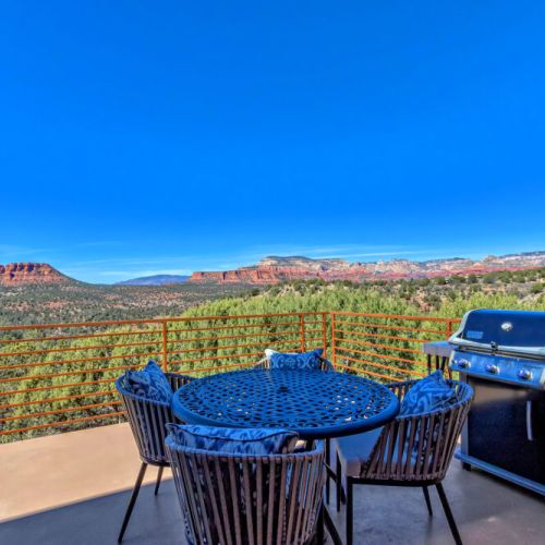 Private outdoor dining space with grill.
