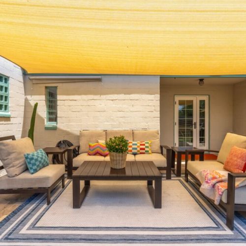 Covered patio with conversation area and Weber Grill