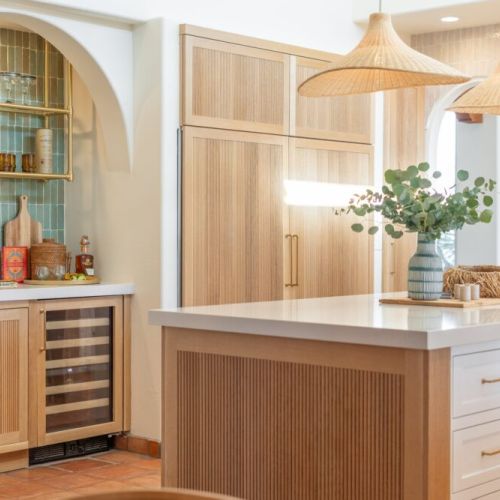 Sunlight spills through large windows, illuminating rustic adobe walls and inviting you to relax.