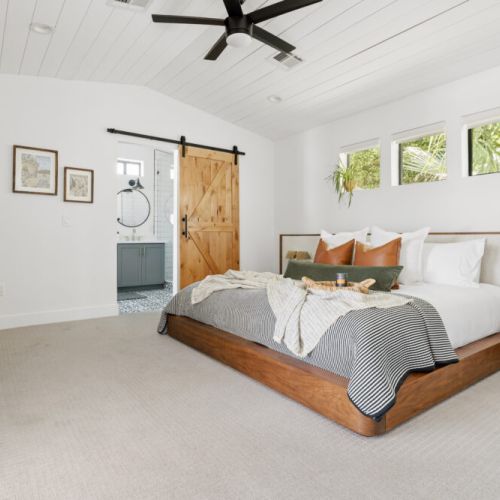 Classic barndoor design feature separates the master bedroom from bath