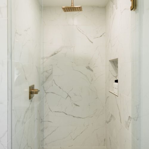 Walk-in shower with gorgeous marble walls