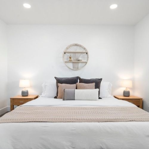 Comfy Master bedroom with reading lamps and premium linens for a perfect nights rest.