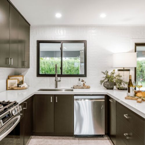 Curated décor, vintage finds, and modern appliances blend into one moody, refined space.