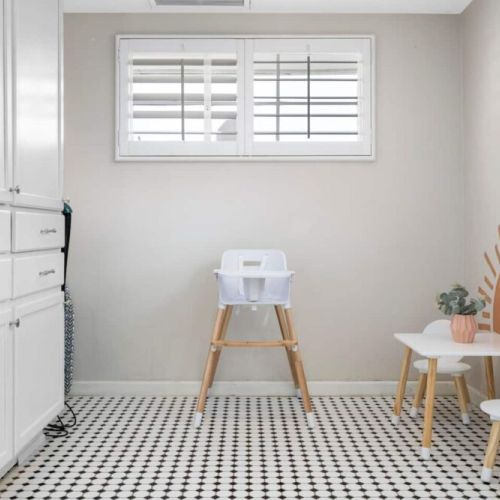 Oversized laundry room with all your laundry needs including laundry soap, ironing board and iron.