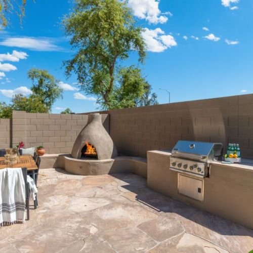 BBQ, fireplace and outdoor dining table