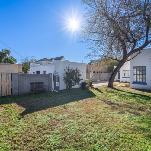 Bright and spacious backyard with plenty of green space, perfect for outdoor activities, or unwinding in the sunshine.
